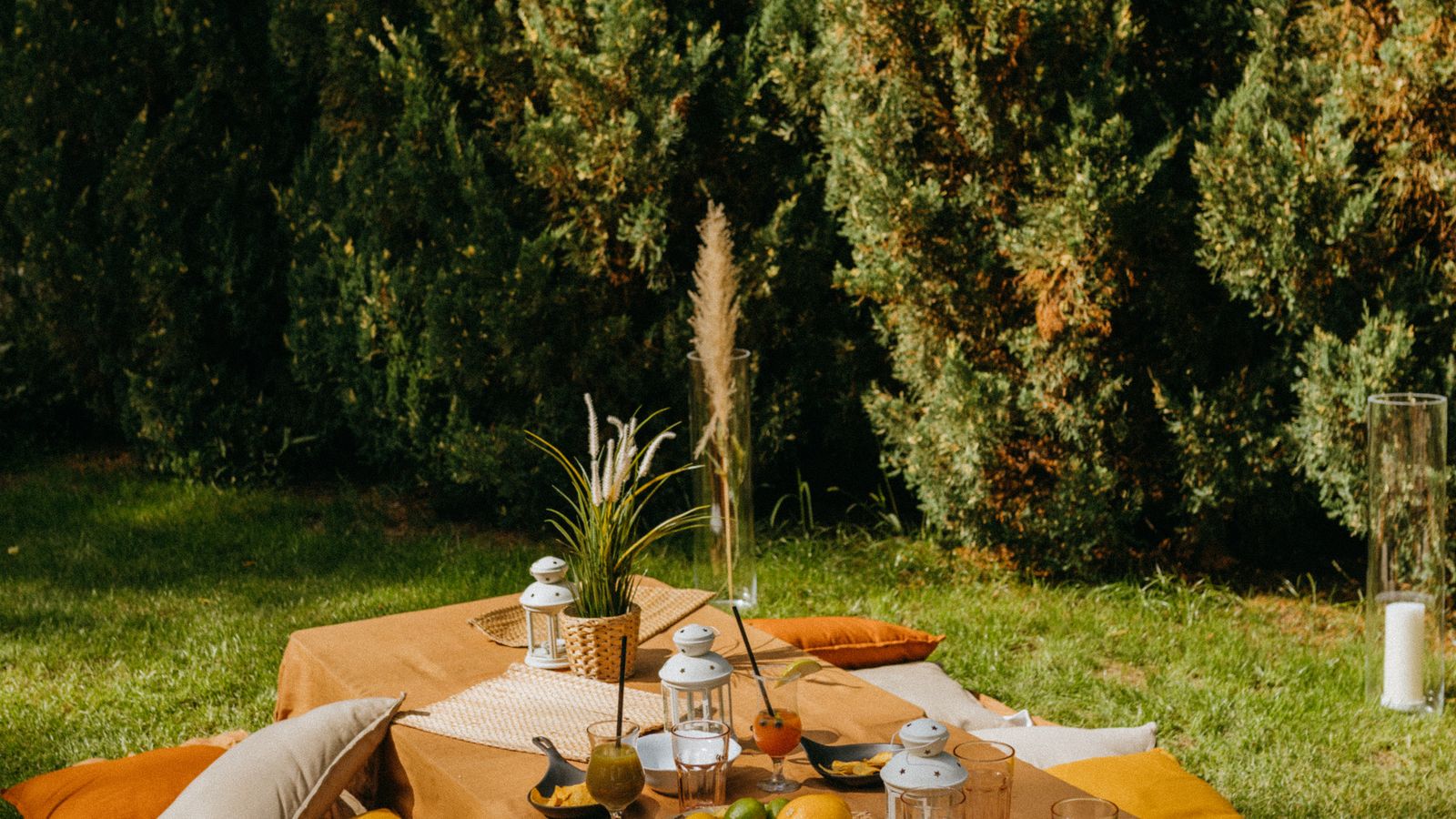 Woven outdoor throw blanket draped over an outdoor patio sofa