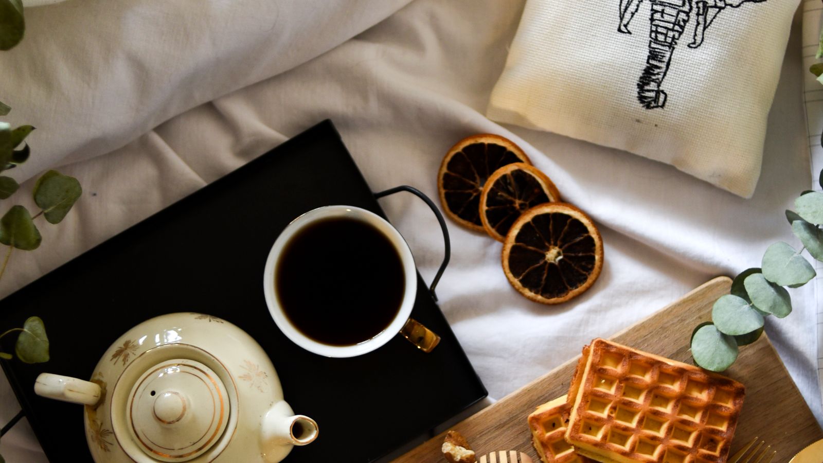 Textured waffle weave blanket folded at the foot of a bed