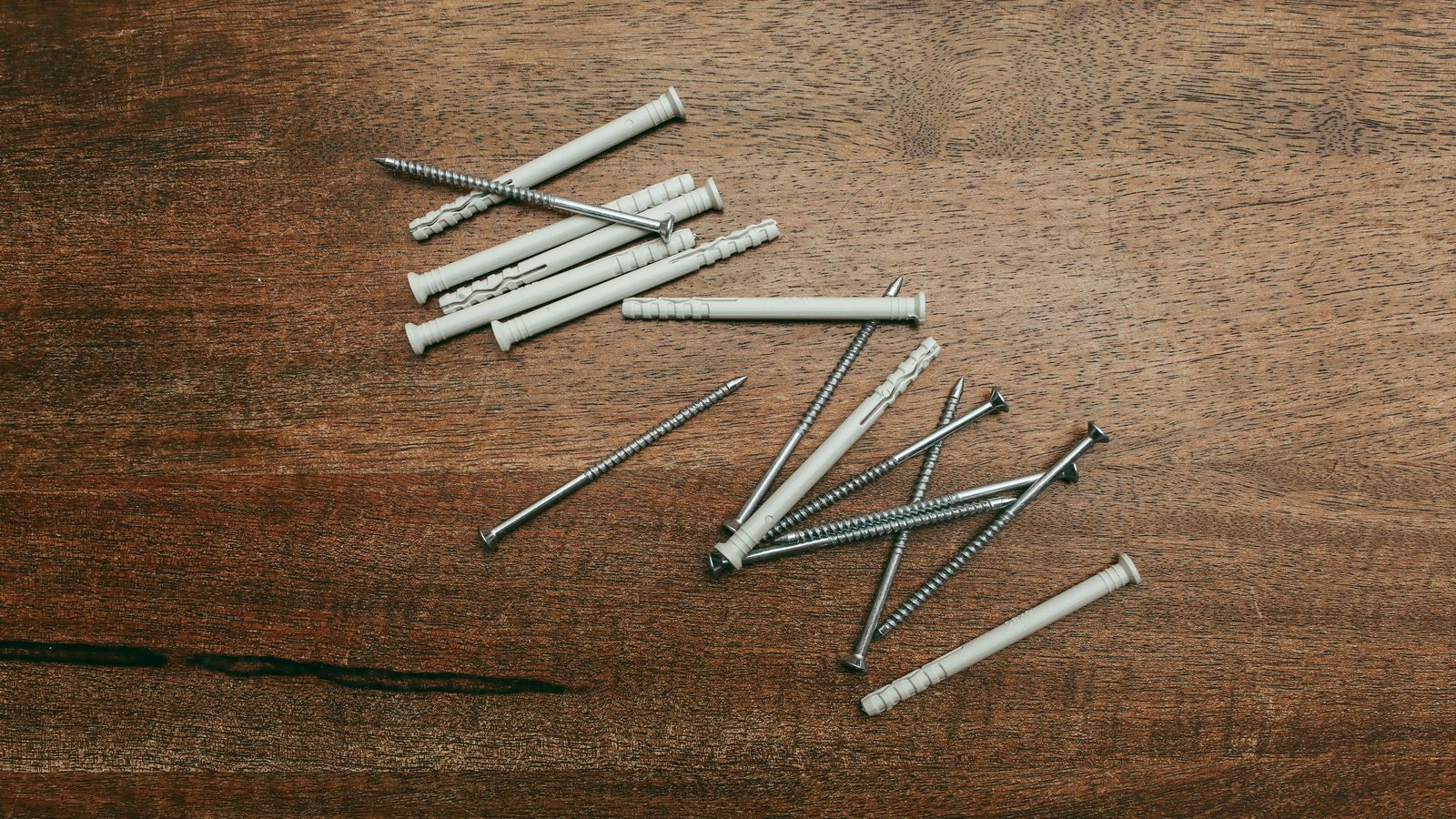 Close-up of wall anchor hardware and screws used for securing furniture and shelving