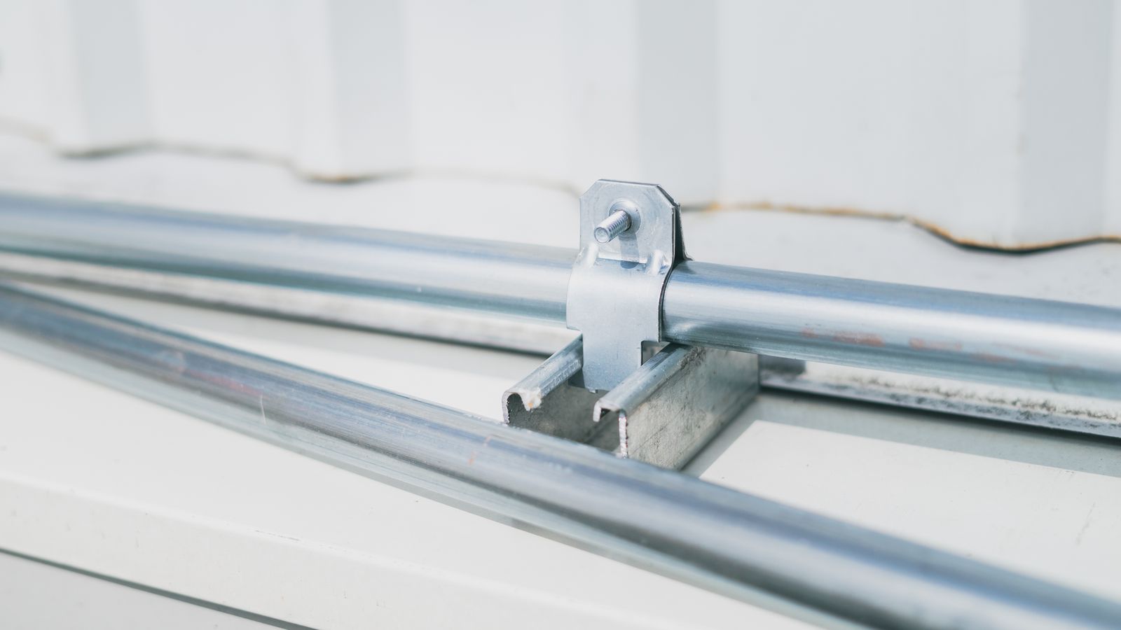 Homeowner installing hardware to mount furniture securely against a wall