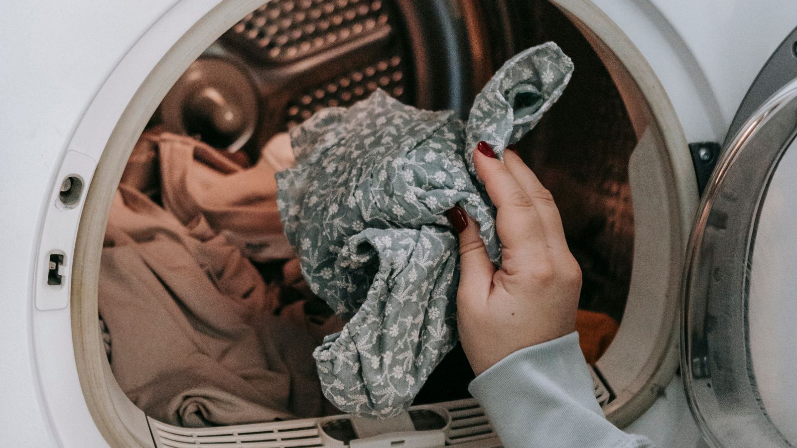 Modern front-loading washer dryer combo installed in a compact laundry closet