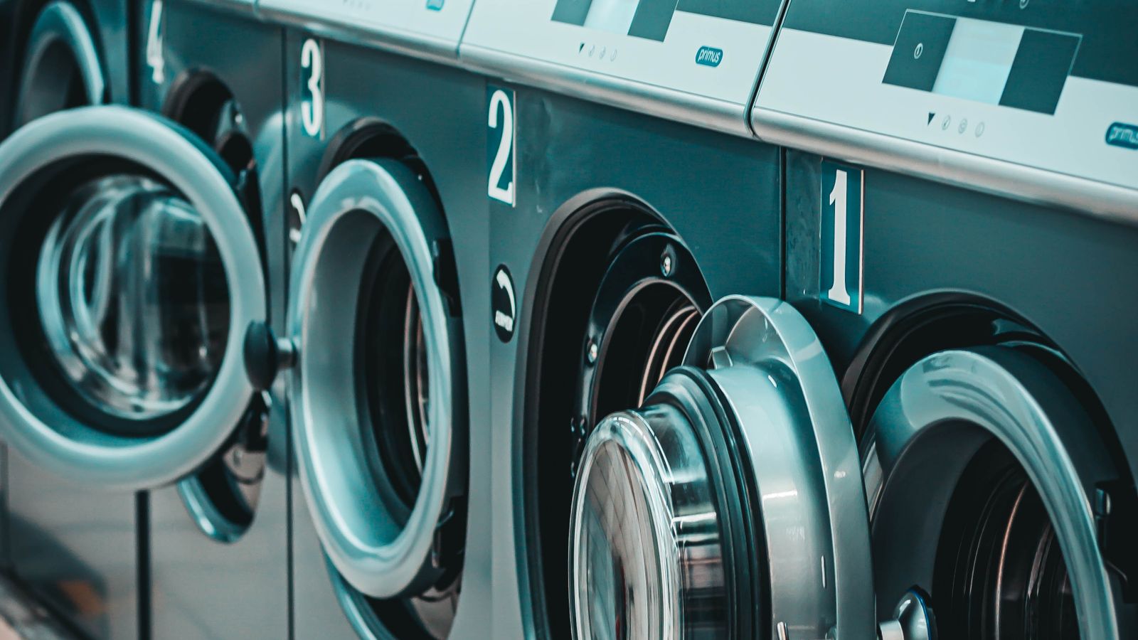 Top load washing machine with an open lid showing a full laundry load